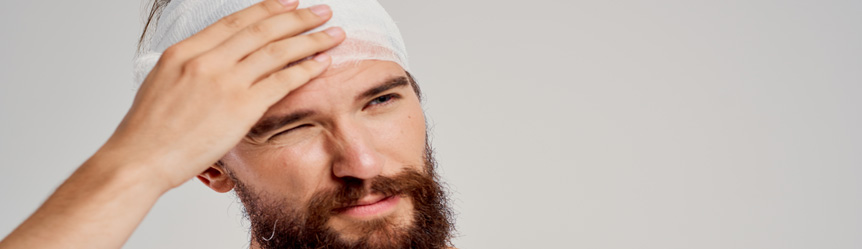 bearded man with bandaged head, operation